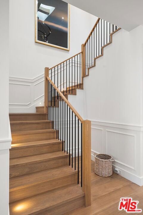 stairs featuring hardwood / wood-style flooring