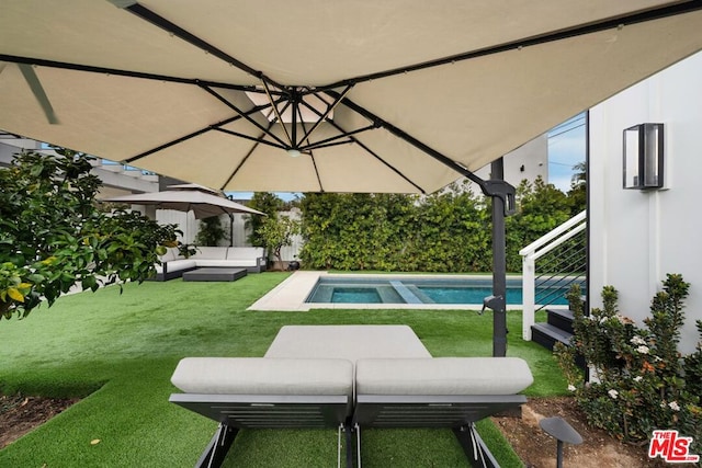 view of swimming pool featuring an outdoor living space and a lawn