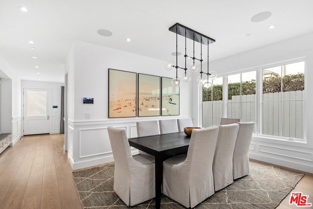 dining space with hardwood / wood-style floors