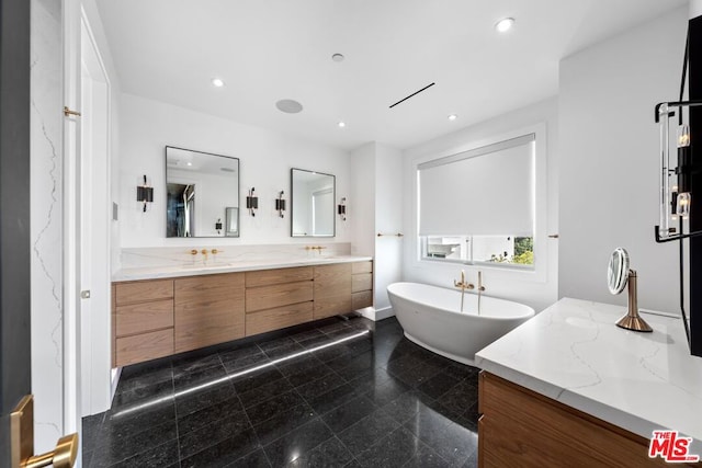 bathroom featuring vanity and a tub