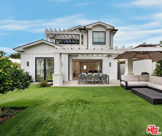 back of house with a patio, outdoor lounge area, a lawn, and a pergola