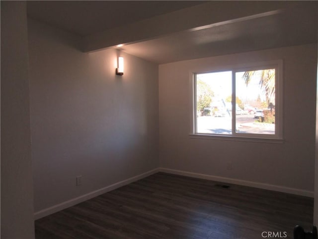 unfurnished room featuring dark wood-type flooring