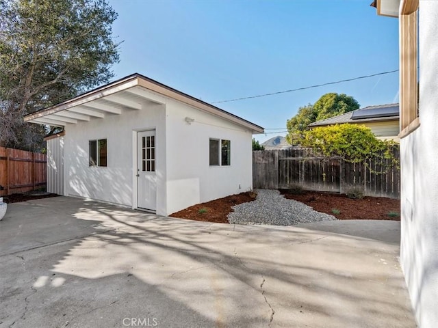 view of side of property featuring a patio area