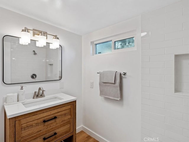 bathroom featuring vanity, hardwood / wood-style floors, and a shower