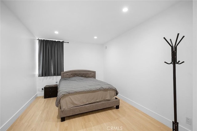 bedroom with hardwood / wood-style floors