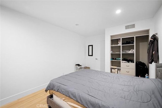 bedroom with hardwood / wood-style floors