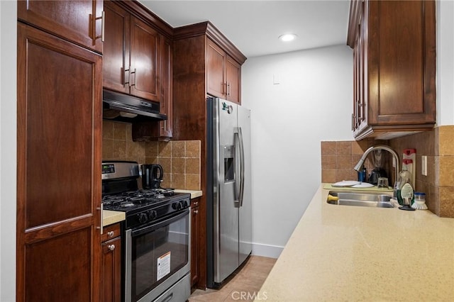 kitchen with tasteful backsplash, stainless steel appliances, and sink