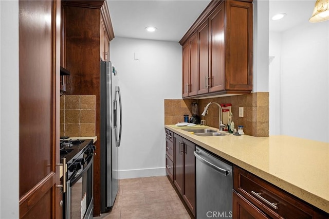 kitchen with sink, decorative backsplash, stainless steel appliances, and light tile patterned floors