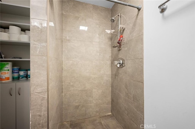 bathroom with a tile shower