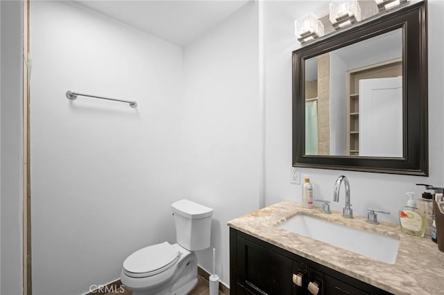 bathroom with vanity and toilet