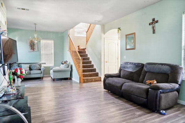 living room featuring wood-type flooring and a chandelier