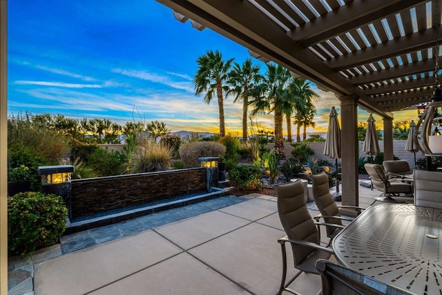 patio terrace at dusk with a pergola