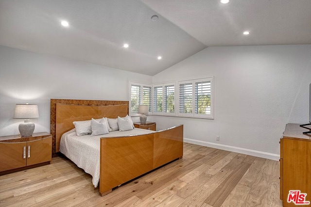 bedroom with lofted ceiling and light hardwood / wood-style floors