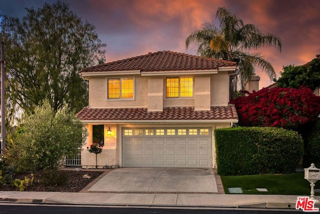 mediterranean / spanish-style house with a garage