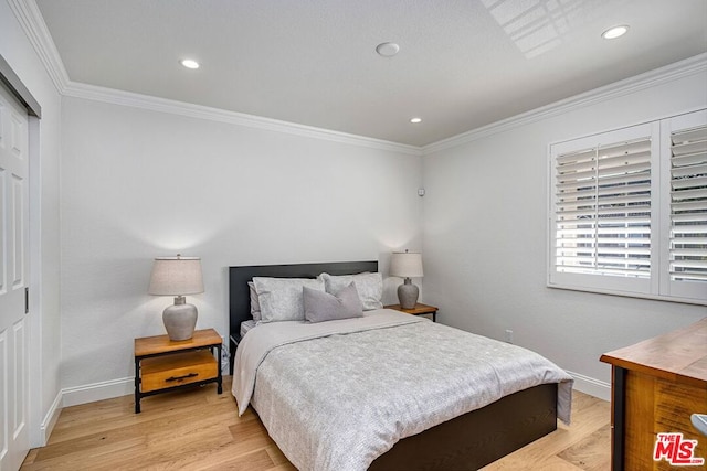 bedroom featuring crown molding, a closet, and light wood-type flooring