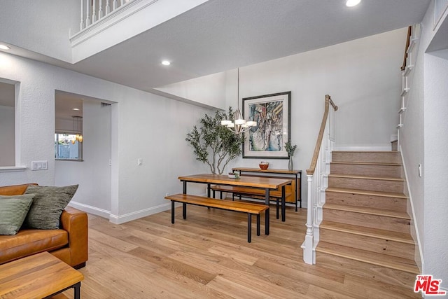 dining space with an inviting chandelier and light hardwood / wood-style flooring