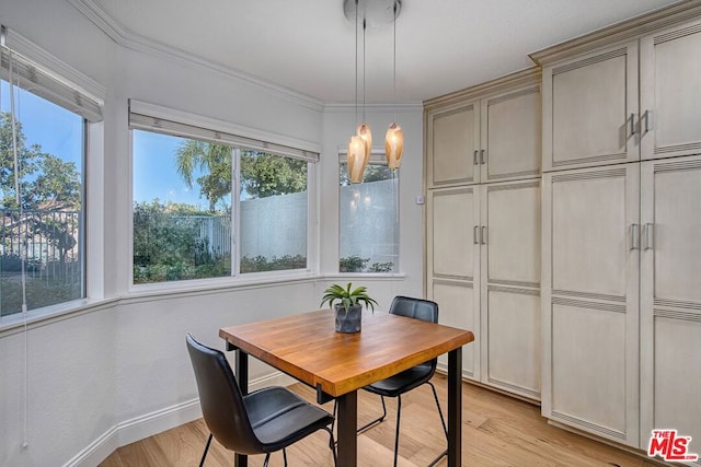 dining area with crown molding and light wood-type flooring