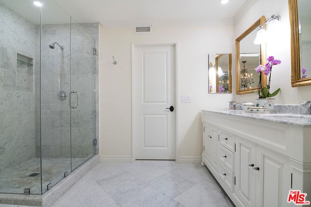 bathroom with tile patterned floors, ornamental molding, an enclosed shower, and vanity