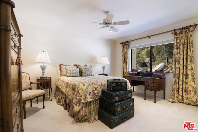 carpeted bedroom featuring ornamental molding and ceiling fan