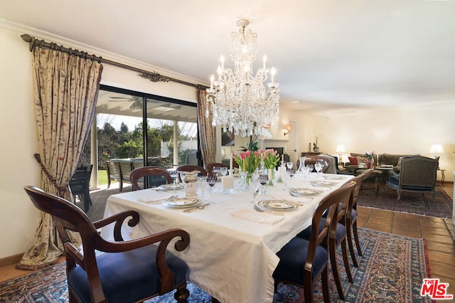 dining space featuring crown molding, dark tile patterned flooring, and a notable chandelier