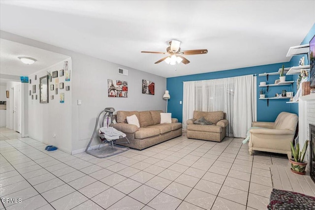 tiled living room with ceiling fan