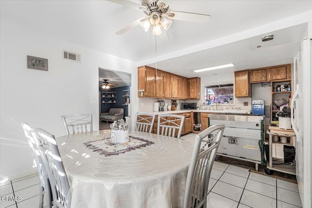 tiled dining area featuring ceiling fan