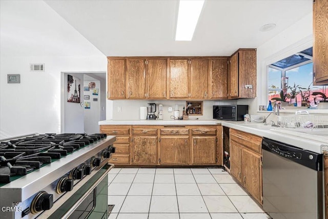 kitchen featuring light tile patterned floors, sink, and appliances with stainless steel finishes