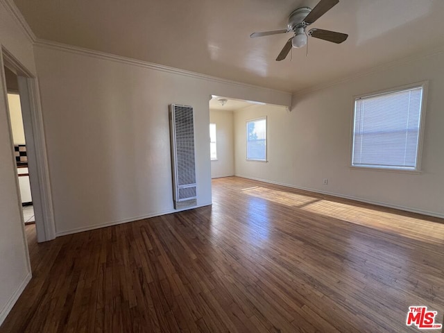 empty room featuring wood-type flooring, ornamental molding, and ceiling fan