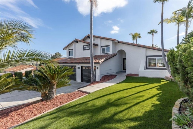 back of property with a garage and a lawn