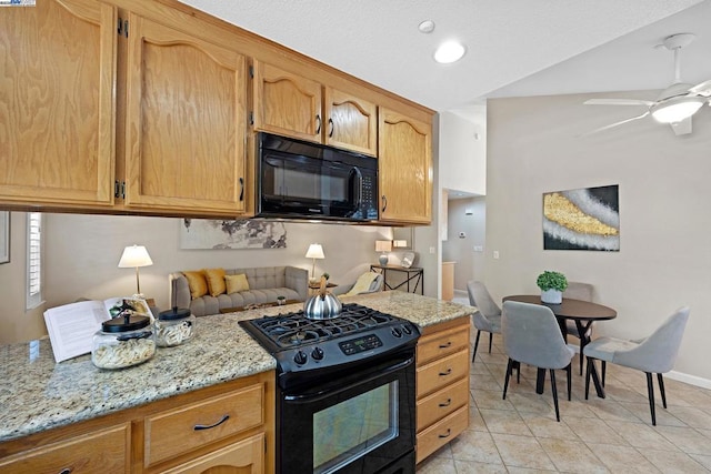 kitchen with lofted ceiling, light tile patterned floors, ceiling fan, light stone countertops, and black appliances