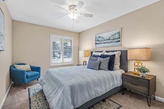 bedroom with ceiling fan and light carpet