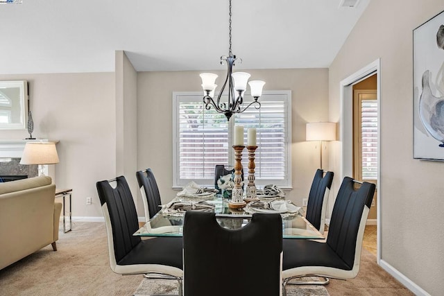 carpeted dining space with an inviting chandelier and lofted ceiling