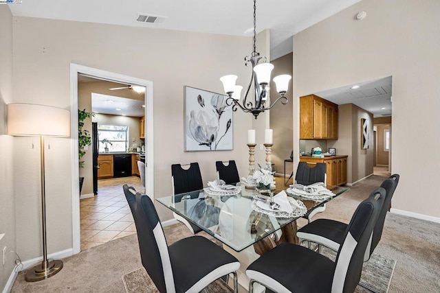 carpeted dining space featuring vaulted ceiling and a notable chandelier