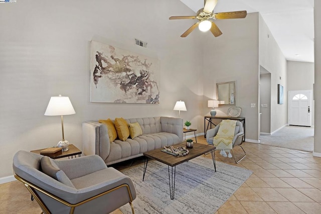 tiled living room featuring a towering ceiling and ceiling fan