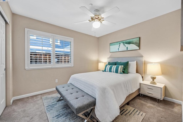 carpeted bedroom with ceiling fan and a closet