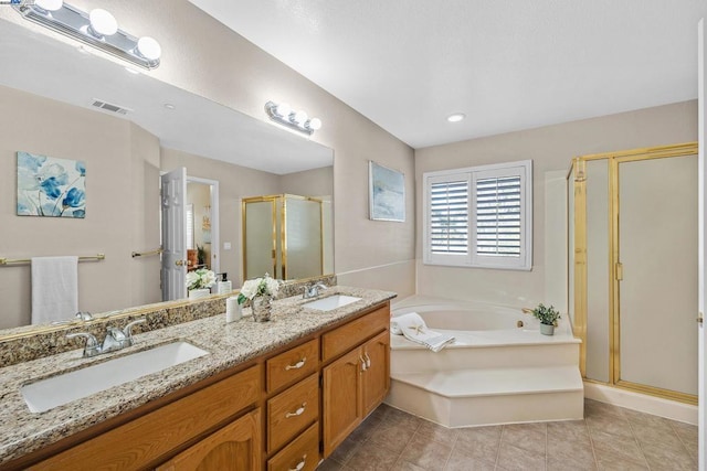 bathroom featuring vanity, separate shower and tub, and tile patterned floors