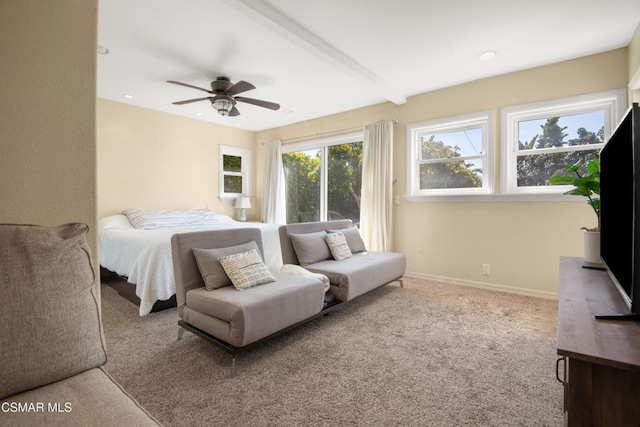 carpeted bedroom with beamed ceiling and ceiling fan