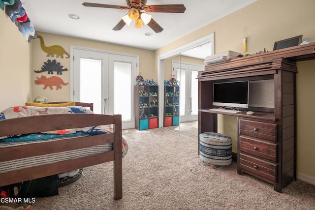 bedroom featuring french doors, light carpet, ceiling fan, and a closet