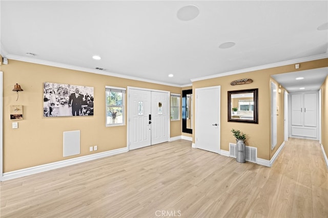 entrance foyer featuring crown molding and light hardwood / wood-style flooring