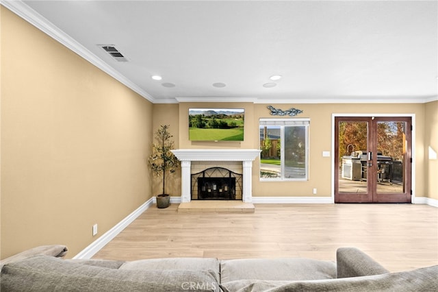 living room featuring crown molding, hardwood / wood-style floors, and french doors