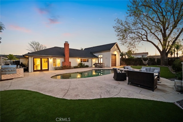 back house at dusk with a fenced in pool, a patio, area for grilling, and an outdoor hangout area