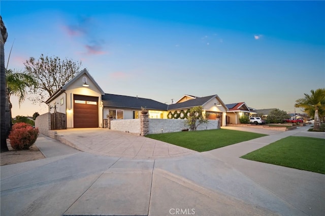 view of front of house with a garage and a lawn