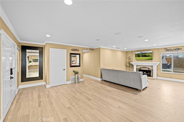 unfurnished living room with crown molding and light wood-type flooring