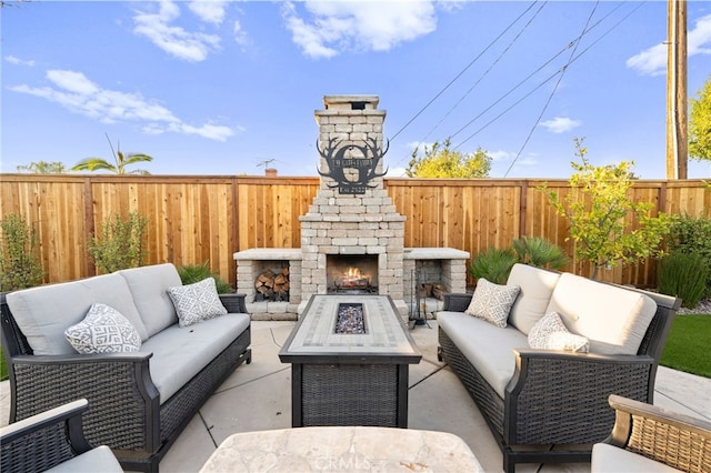 view of patio with an outdoor living space with a fireplace