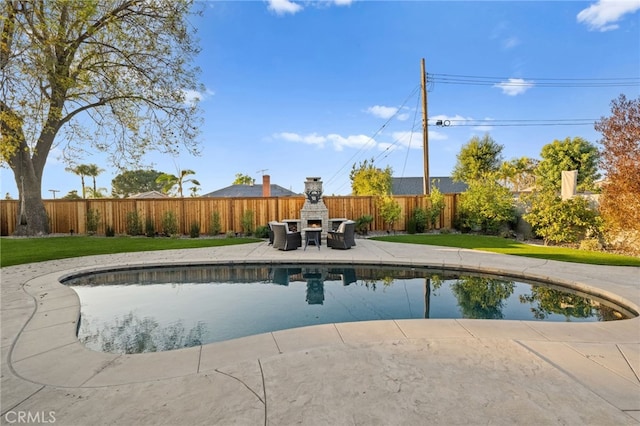 view of pool featuring a yard and a patio area