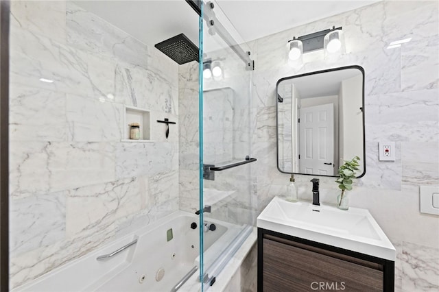 bathroom featuring vanity, tiled shower / bath combo, and tile walls