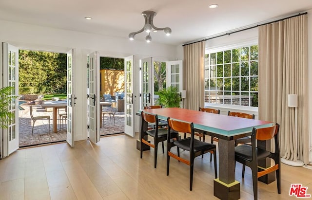 dining room featuring french doors and light wood-type flooring