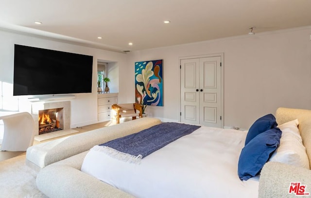 bedroom with crown molding and a closet