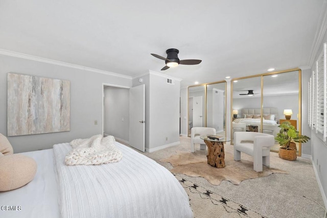 carpeted bedroom featuring multiple closets, ornamental molding, and ceiling fan