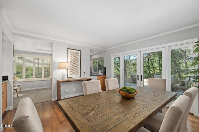 dining area with ornamental molding, sink, hardwood / wood-style floors, and french doors